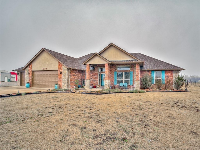 view of front facade featuring a garage, concrete driveway, brick siding, and a front lawn