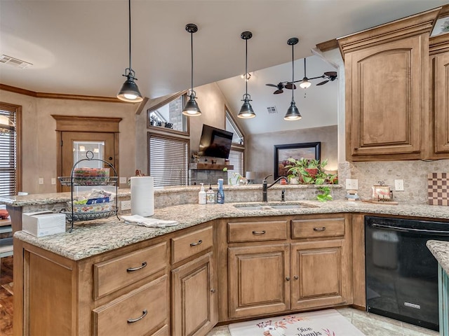 kitchen with sink, black dishwasher, pendant lighting, light stone countertops, and backsplash