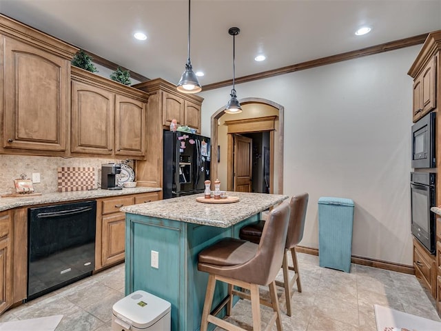 kitchen featuring light stone countertops, black appliances, arched walkways, and a center island