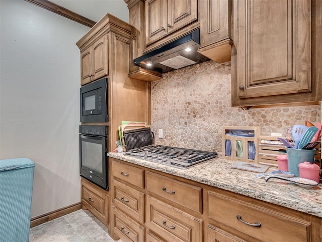 kitchen featuring light stone counters, range hood, decorative backsplash, ornamental molding, and black appliances