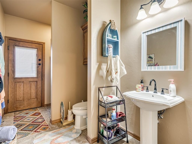 bathroom featuring sink and toilet