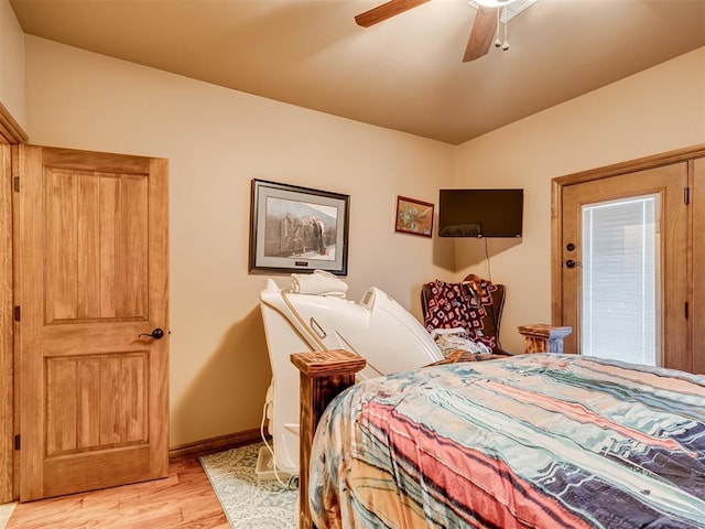 bedroom with ceiling fan, light wood finished floors, and baseboards