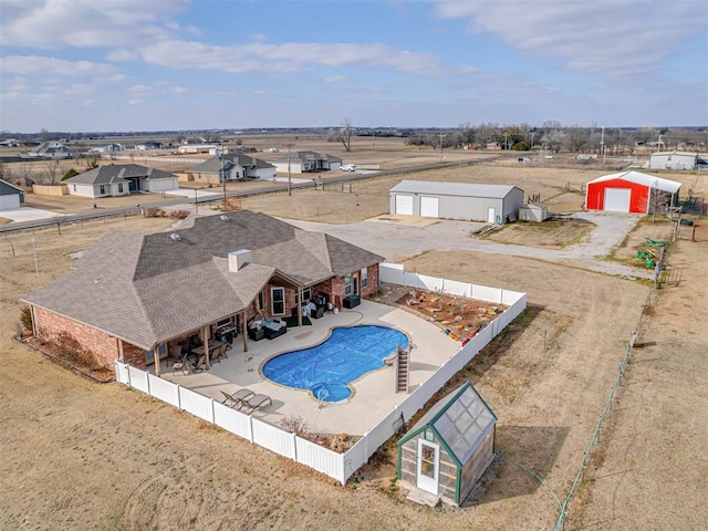 view of pool with a patio area, a fenced backyard, a fenced in pool, and an outbuilding