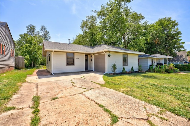 ranch-style house with a garage and a front yard