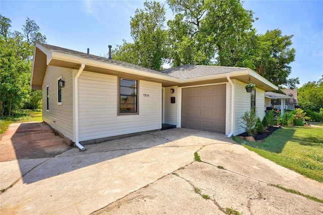 ranch-style home with a garage and a front yard