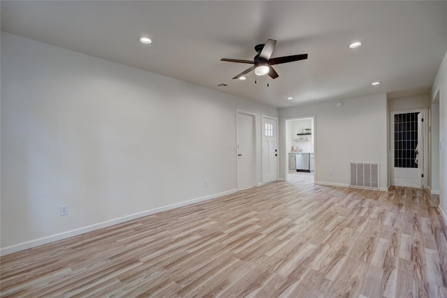 unfurnished living room featuring ceiling fan and light wood-type flooring