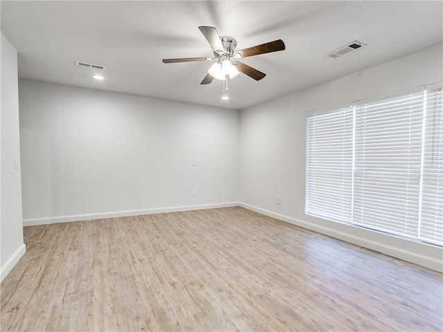 spare room with ceiling fan and light hardwood / wood-style floors