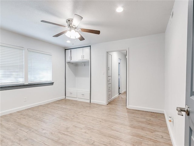 unfurnished bedroom with a closet, ceiling fan, and light wood-type flooring