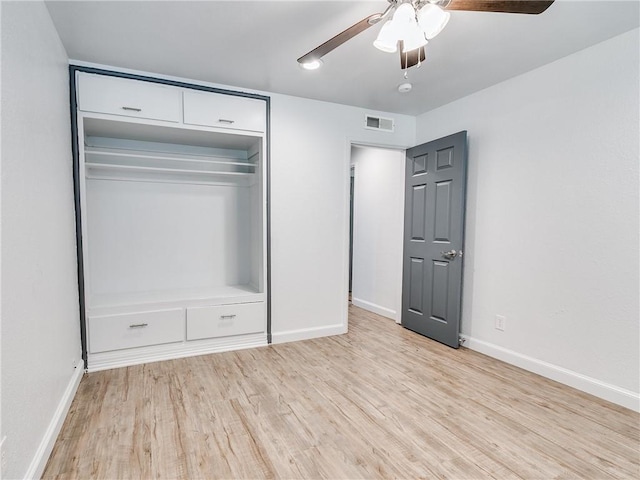 unfurnished bedroom featuring ceiling fan, light hardwood / wood-style floors, and a closet