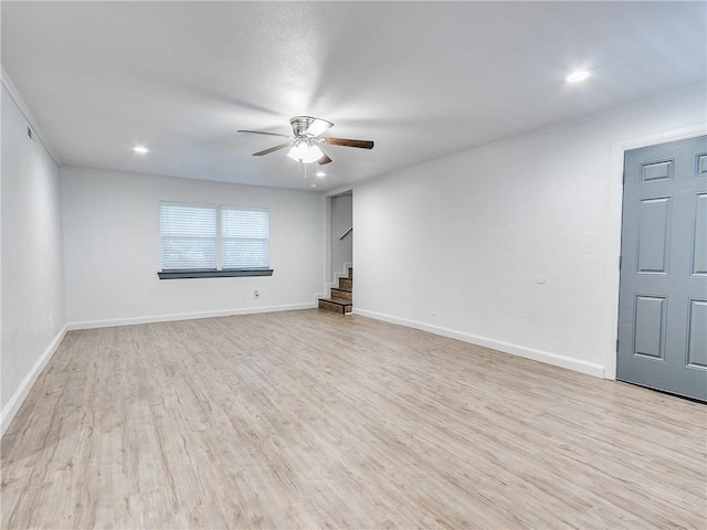 empty room with crown molding, light hardwood / wood-style flooring, and ceiling fan