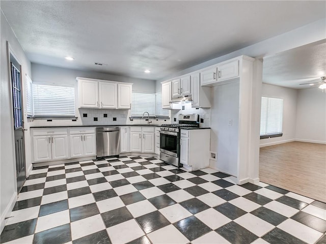 kitchen featuring white cabinetry, sink, decorative backsplash, and stainless steel appliances