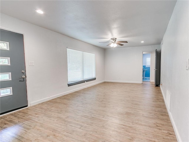 empty room featuring ceiling fan and light hardwood / wood-style flooring