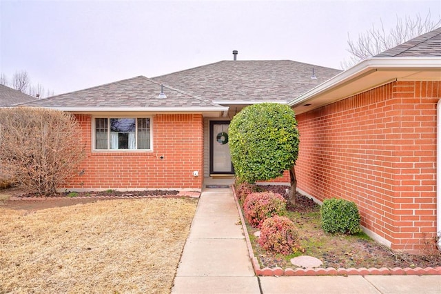 doorway to property featuring a lawn