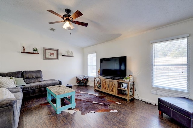 living room with ceiling fan, lofted ceiling, and dark hardwood / wood-style flooring