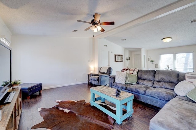 living room with lofted ceiling with beams, ceiling fan, a textured ceiling, and dark hardwood / wood-style flooring