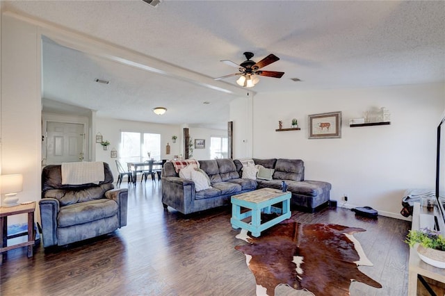 living room with ceiling fan, lofted ceiling, a textured ceiling, and dark hardwood / wood-style flooring