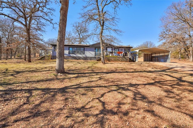 view of front of property featuring a carport and a front lawn