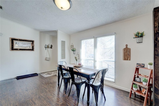 dining area with ornamental molding, dark hardwood / wood-style floors, and a textured ceiling