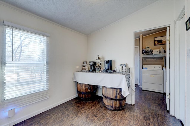 interior space with dark hardwood / wood-style floors, ornamental molding, washer / clothes dryer, and a textured ceiling