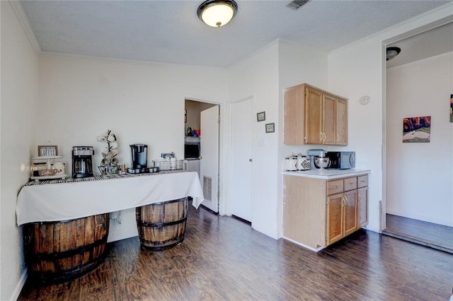 kitchen with dark wood-type flooring, ornamental molding, and light brown cabinets