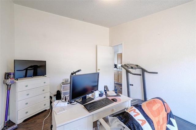 office featuring a textured ceiling and dark hardwood / wood-style flooring