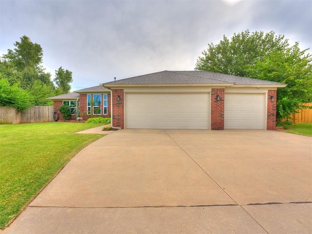 ranch-style house with a garage and a front yard