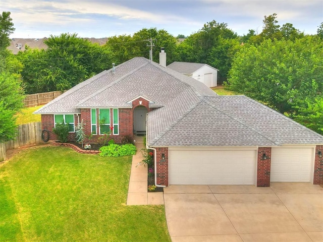 ranch-style house featuring a garage and a front lawn