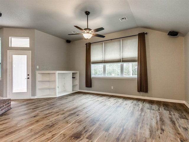 unfurnished living room with hardwood / wood-style flooring, lofted ceiling, and ceiling fan