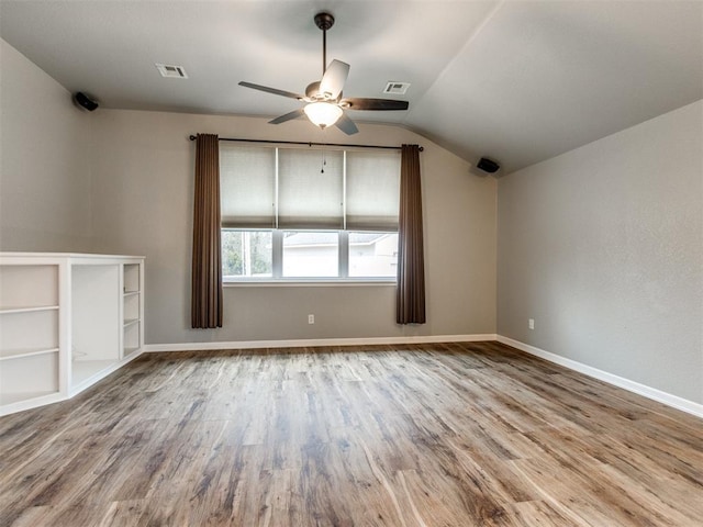 unfurnished room featuring hardwood / wood-style floors, vaulted ceiling, and ceiling fan