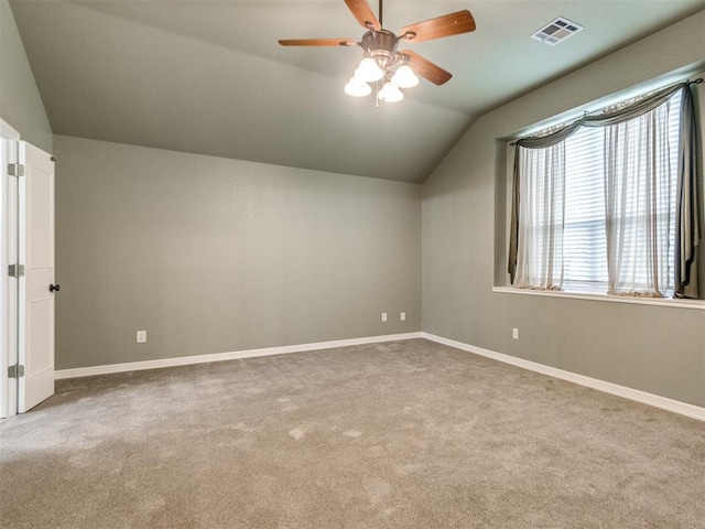 additional living space featuring vaulted ceiling, light colored carpet, and ceiling fan