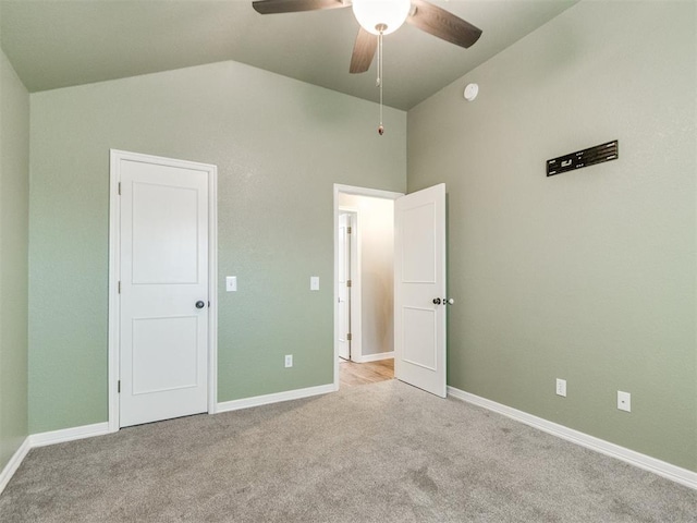 unfurnished bedroom with light carpet, vaulted ceiling, and ceiling fan