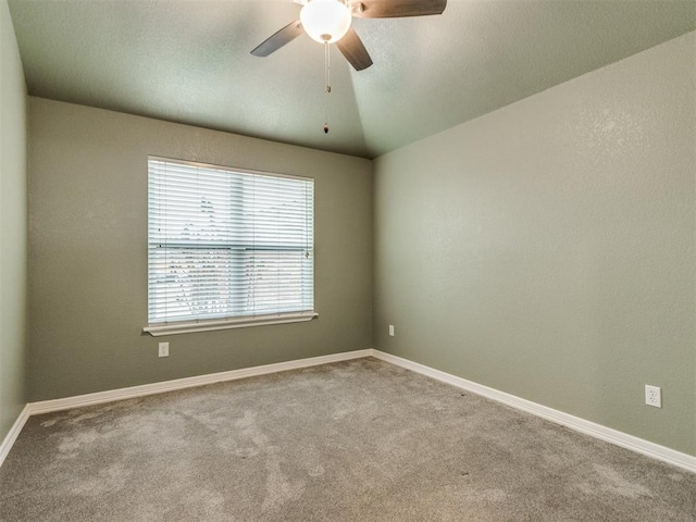 empty room with ceiling fan, light colored carpet, and lofted ceiling