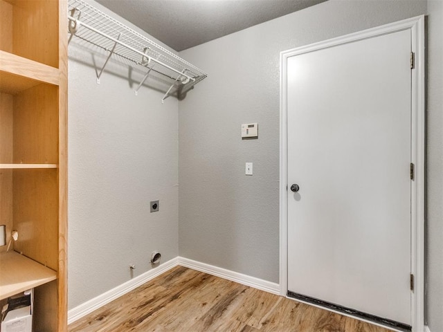 laundry area featuring hookup for a gas dryer, electric dryer hookup, and hardwood / wood-style floors