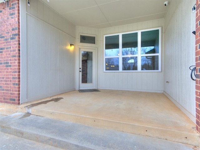 property entrance featuring a patio area