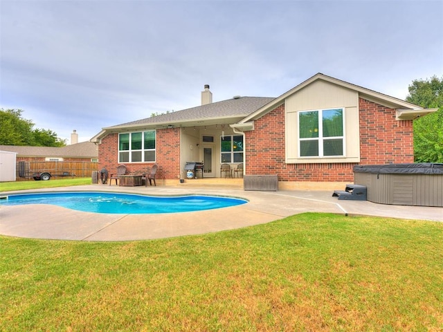 view of pool featuring a hot tub, a patio, a grill, and a lawn