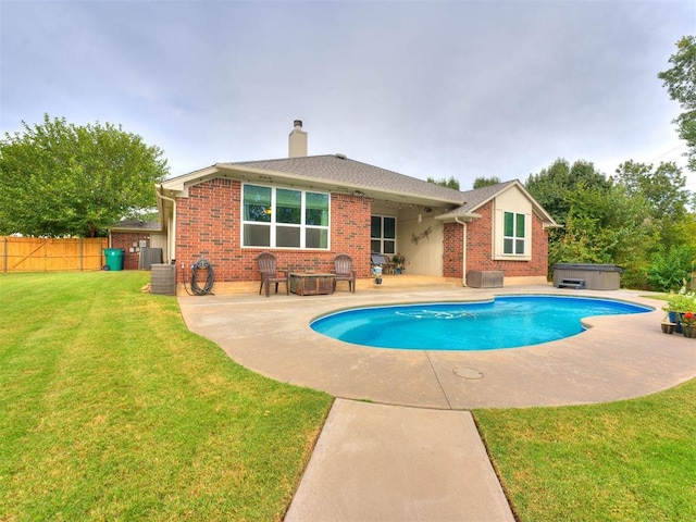 view of swimming pool featuring a fire pit, a lawn, central AC, a patio area, and a hot tub