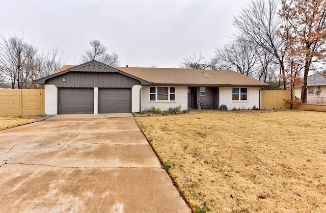 ranch-style home featuring a garage and a front yard