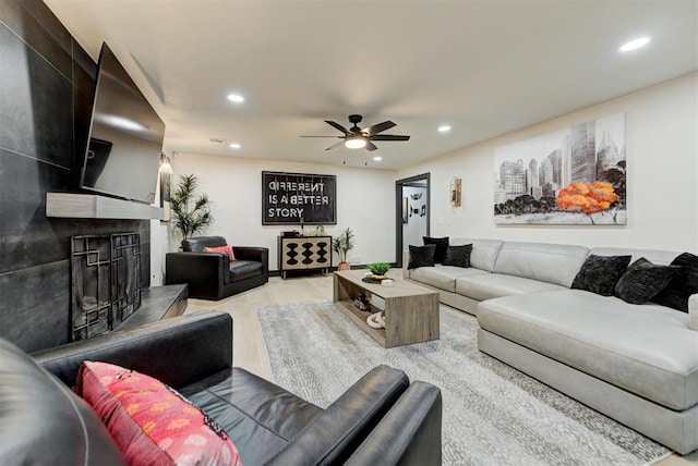 living room featuring ceiling fan and light wood-type flooring