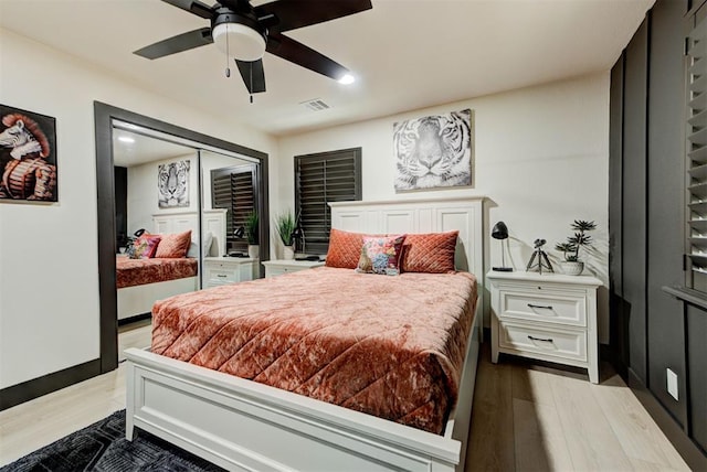 bedroom with ceiling fan and light hardwood / wood-style floors