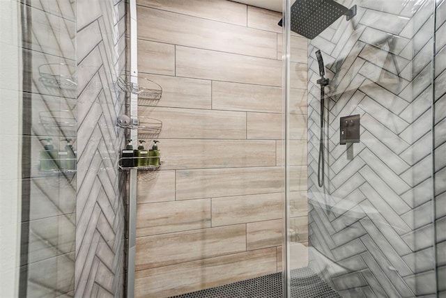 bathroom with a shower with door