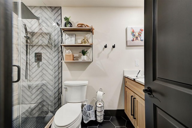 bathroom featuring vanity, an enclosed shower, tile patterned floors, and toilet