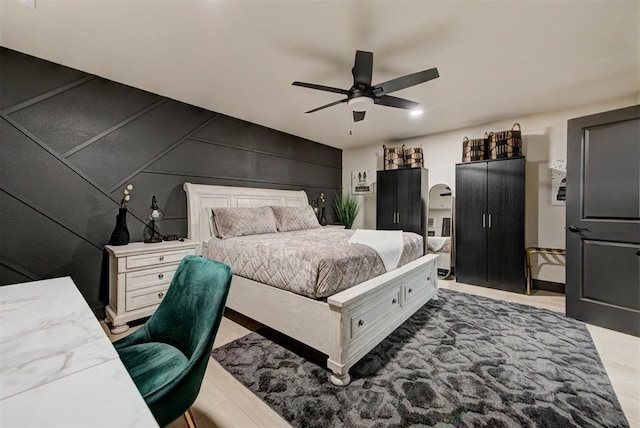 bedroom with light wood-type flooring and ceiling fan