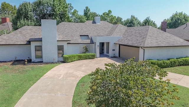 view of front of home featuring a garage and a front lawn