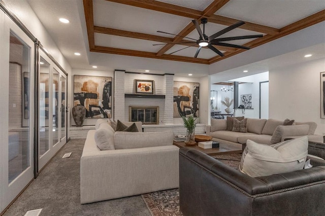 living room with a fireplace, coffered ceiling, dark carpet, and beam ceiling