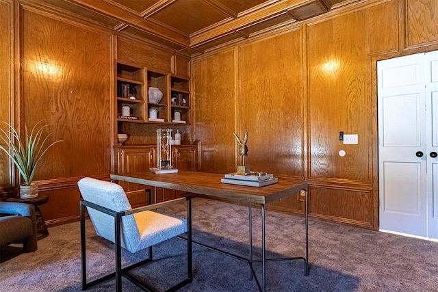 office area featuring built in features, coffered ceiling, ornamental molding, dark carpet, and wood walls