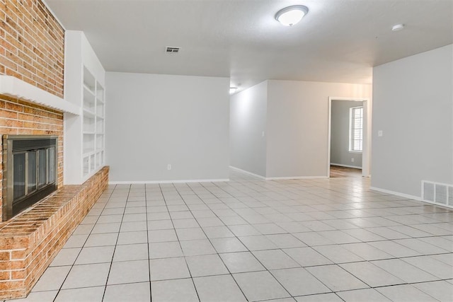 unfurnished living room with baseboards, visible vents, built in features, and a fireplace