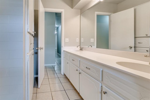 bathroom featuring double vanity, a sink, and tile patterned floors