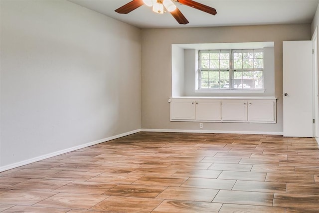 unfurnished room featuring ceiling fan, baseboards, and light wood finished floors