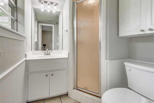 bathroom with visible vents, a stall shower, vanity, tile patterned floors, and toilet