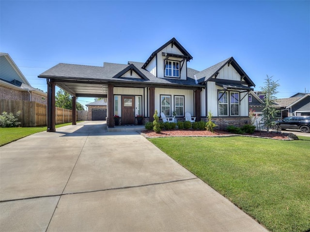 view of front of property with a front lawn, a carport, and covered porch